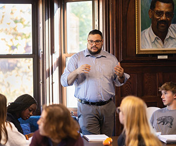 A teacher in a classroom. Links to Donor-Advised Funds