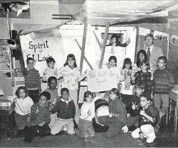 In 1987 Bill’s fourth-grade students (Class of 1995) posed in front of a model Spirit of St. Louis they built in their classroom. 